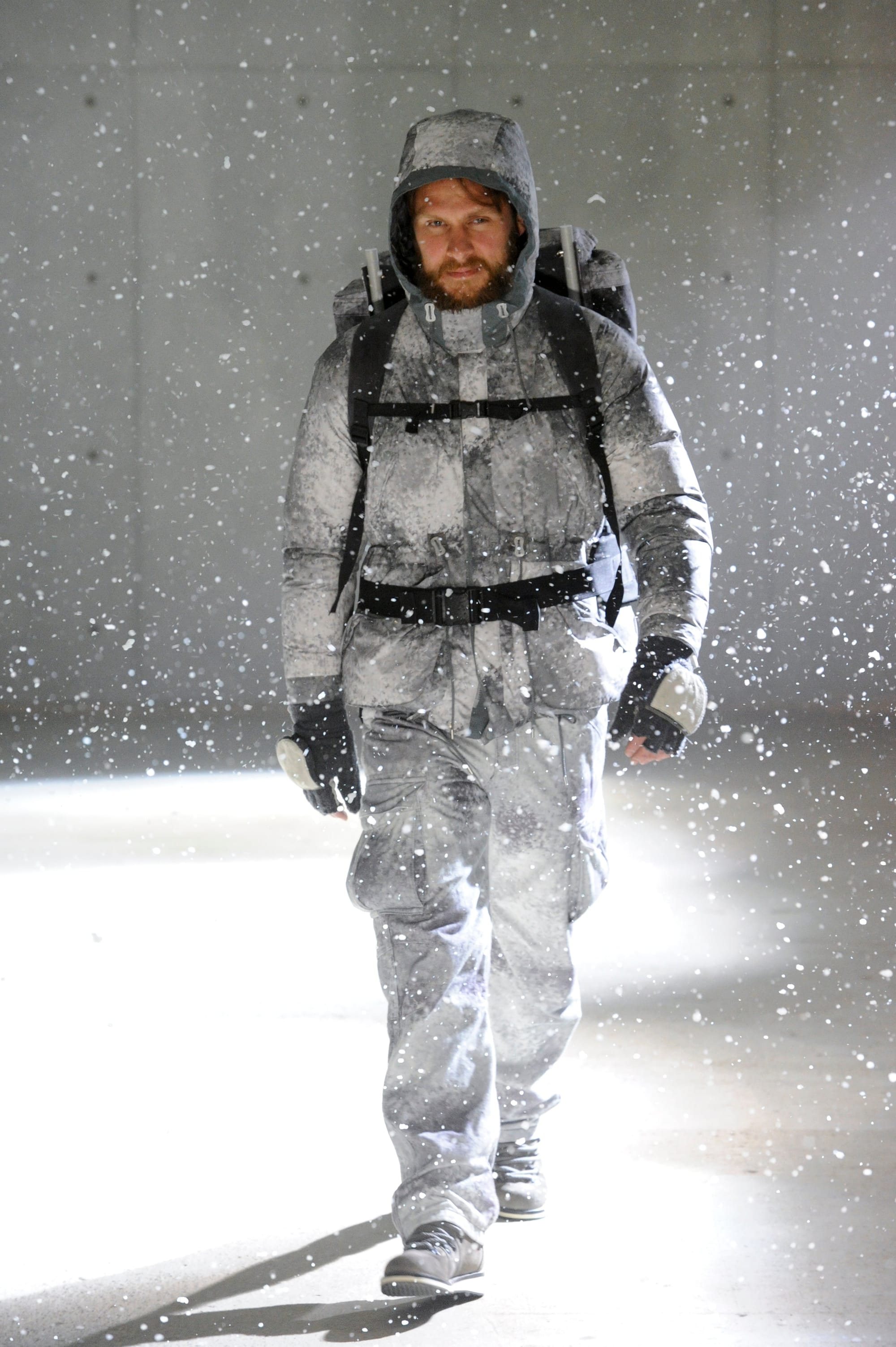 White Mountaineering Wilderness Outfitters look 9: grey camouflage knit, patterned trousers and black fur gaiters.