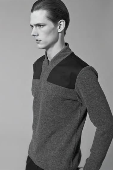Profile view of a grey Stahl Corporation knit with black shoulder panels.