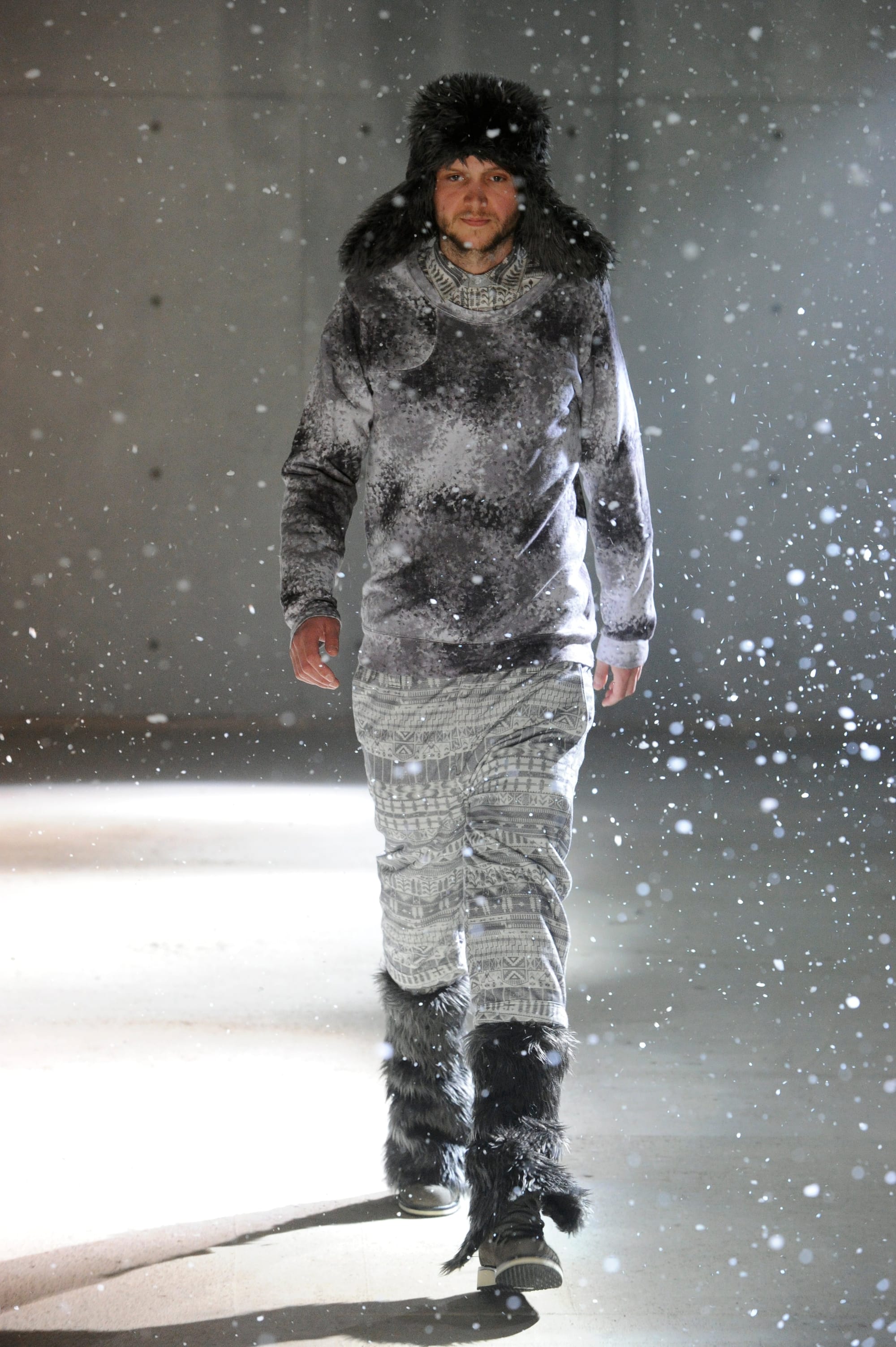 White Mountaineering Wilderness Outfitters look 10: rust patterned field jacket, jacquard scarf and layered knit shorts.