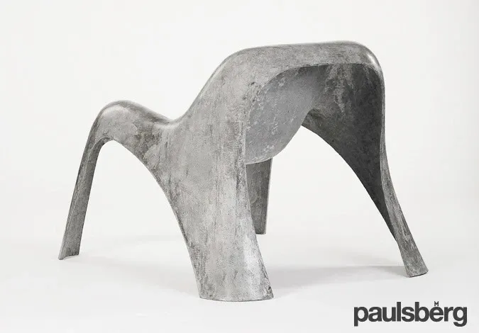 Rear three-quarter view of the grey Paulsberg Spurt carbon-textile-reinforced concrete lounge chair.