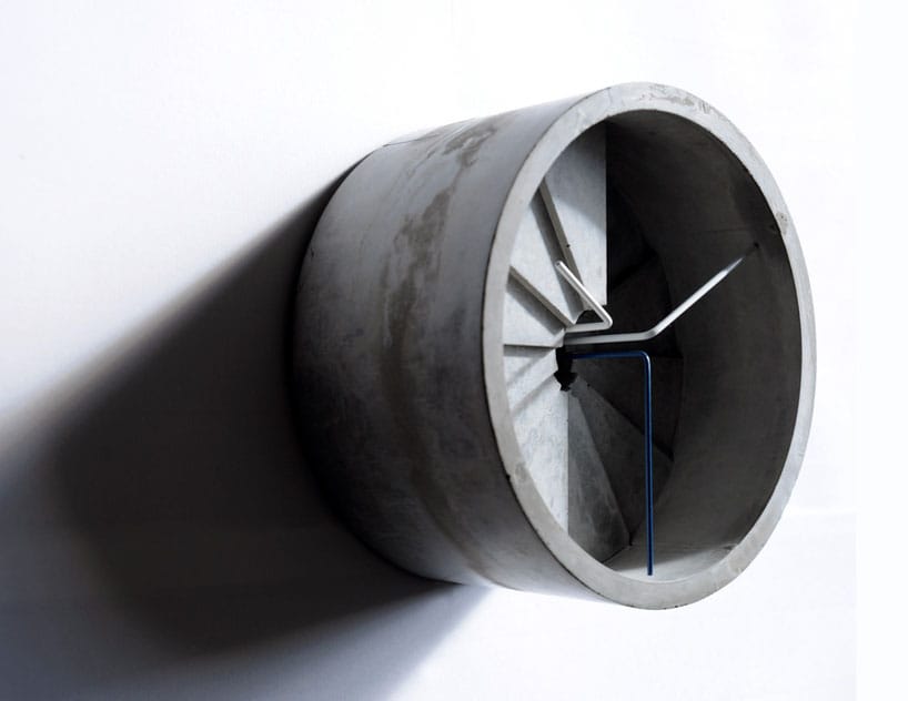 Side view of the deep cylindrical 4th Dimension concrete clock and its descending spiral-hour steps.