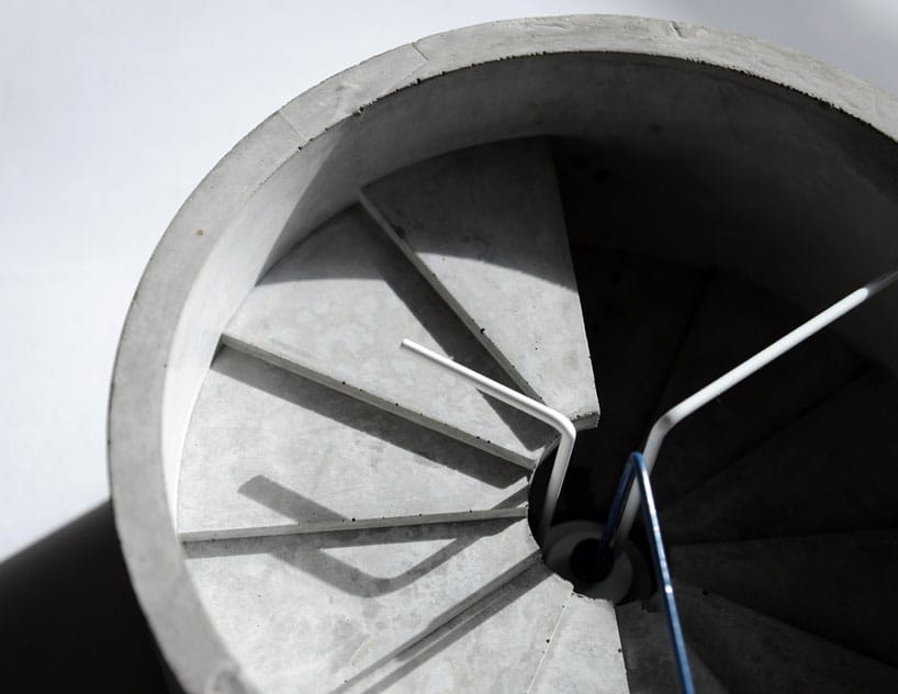 Close view of the 4th Dimension Clock's concrete spiral steps, white hands and blue second hand.