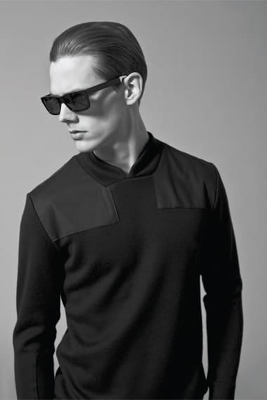 Johannes Niermann in sunglasses and a black knit with structured shoulder panels.