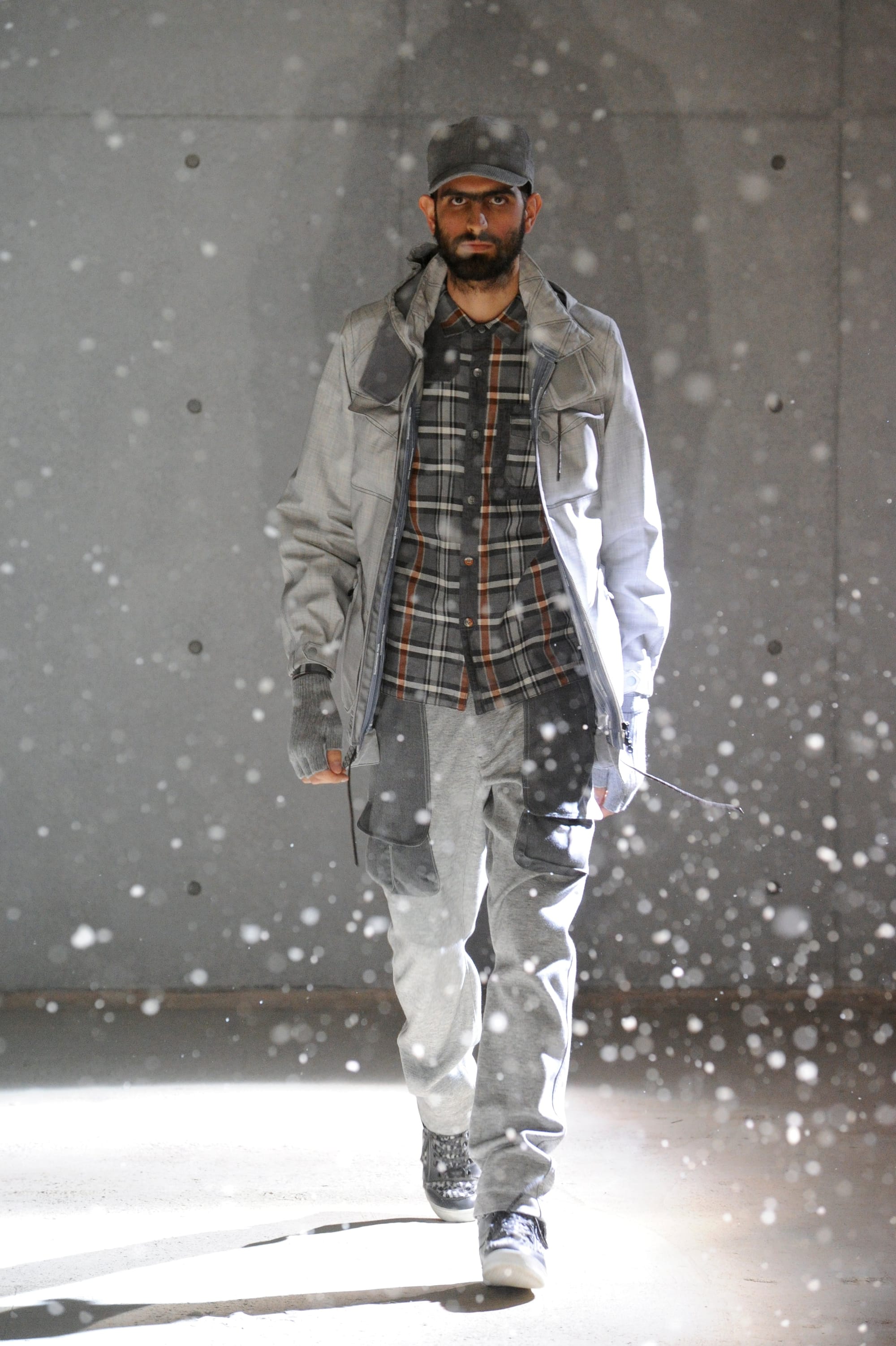 White Mountaineering Wilderness Outfitters look 16: grey hooded knit under a black tactical utility vest.
