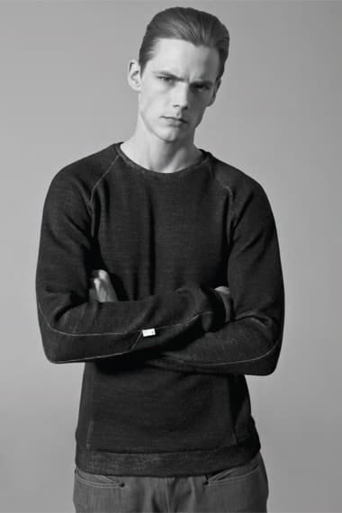 Johannes Niermann in a dark raglan crewneck knit from Stahl Corporation Fall/Winter 2012.