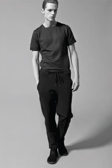 Johannes Niermann in a black short-sleeve top and drawstring trousers from Stahl Corporation.