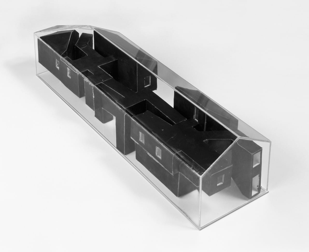 Physical model showing the dark inserted room volumes within the preserved Casa dos Cubos shell.