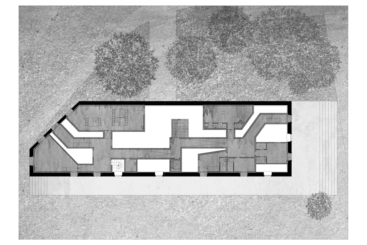 Casa dos Cubos first-floor plan showing rooms, stairs and circulation around the central voids.