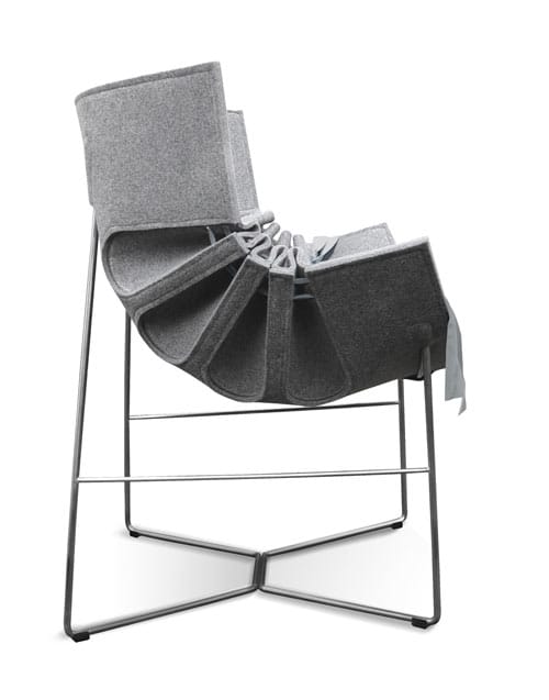 Side view of the Bufa Chair showing its gathered grey felt shell and slender stainless-steel frame.