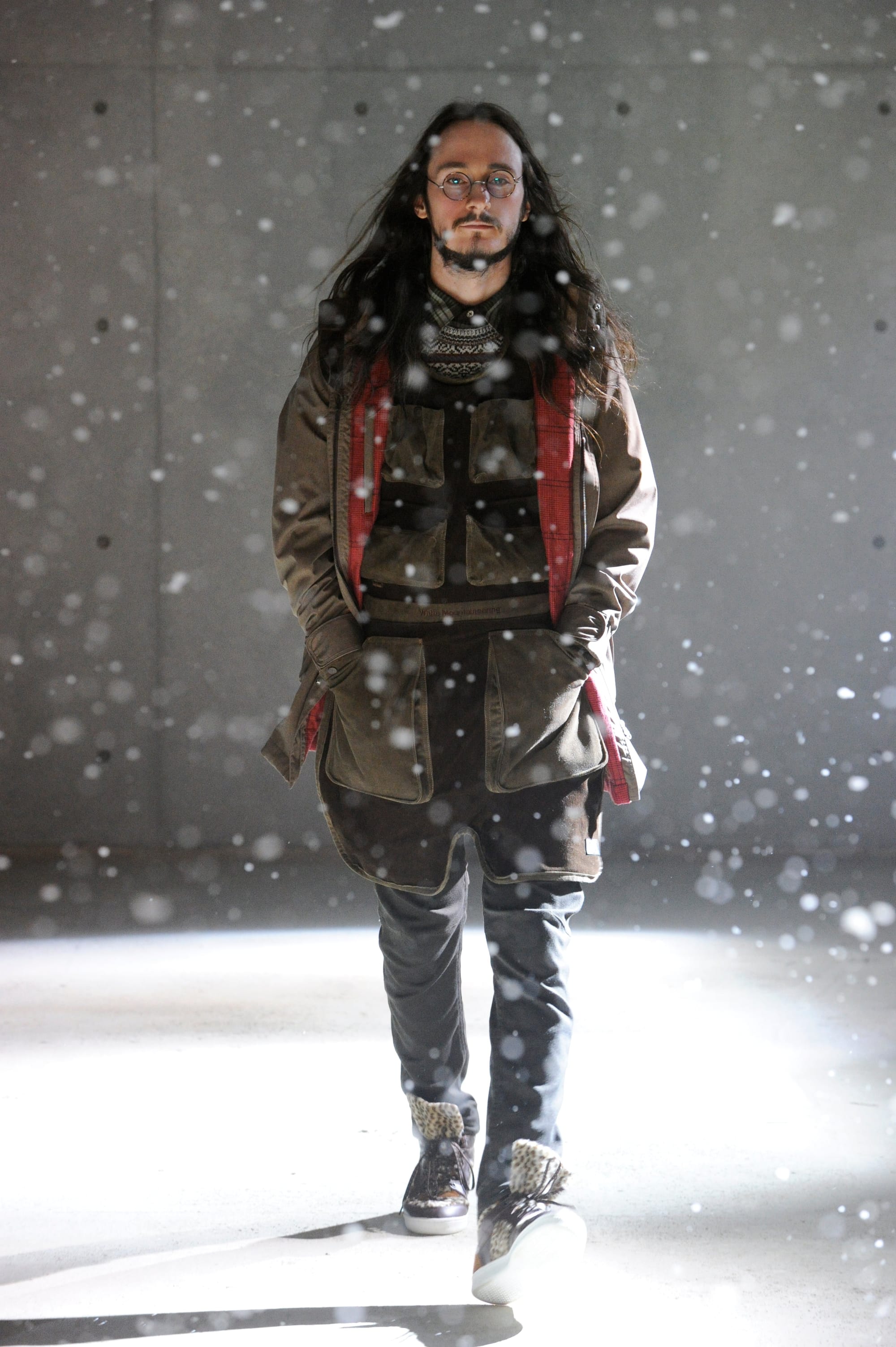 White Mountaineering Wilderness Outfitters look 24: black fur vest, long shirt, quilted trousers and patterned tote.