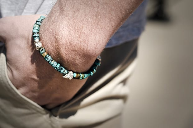 Close view of a Deadwood turquoise bead bracelet with a small silver skull accent.