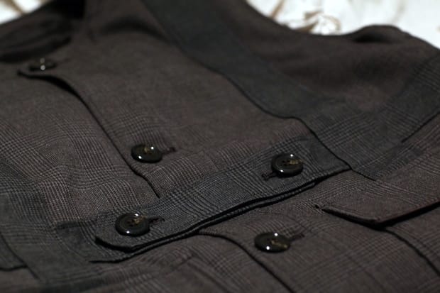 Close view of black buttons and gun-club-check fabric on the SILLY THING x N. Hoolywood Homage to 221B waistcoat.