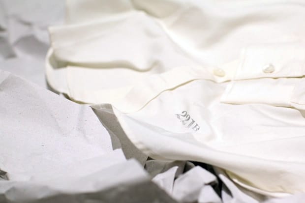 Close view of the 221B mark on the white Homage to 221B shirt.