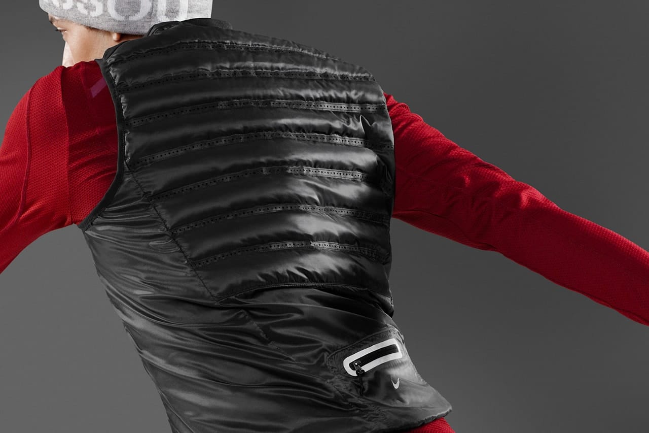 Runner in a purple Gyakusou Holiday 2013 hooded jacket