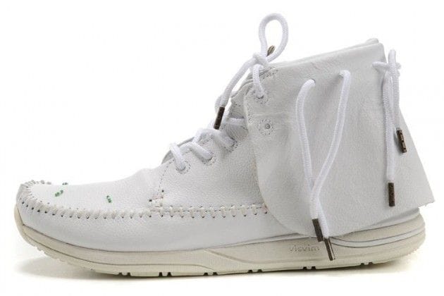 White Visvim high-top shoe with hand-stitched moccasin construction.