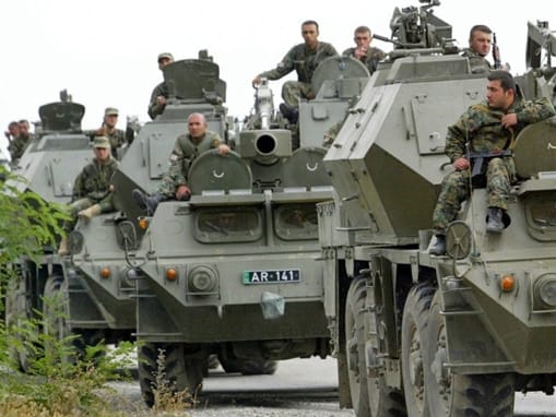 Georgian troops riding armored personnel carriers as they enter South Ossetia.