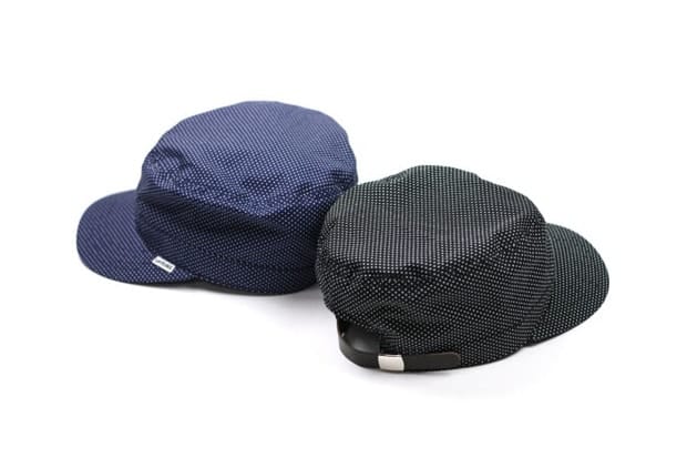 Two UNTOLD small-dot caps in navy and black, shown from the side and rear.