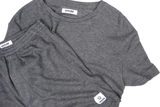 UNTOLD grey waffle-knit T-shirt and matching bottoms with woven labels and a circular logo patch.