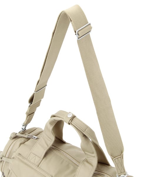 Beige adjustable shoulder strap attached to the PORTER Boston bag.
