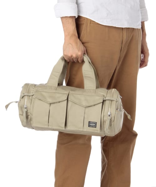 Beige PORTER PEACE BOSTON BAG MEDIUM carried by its top handles.