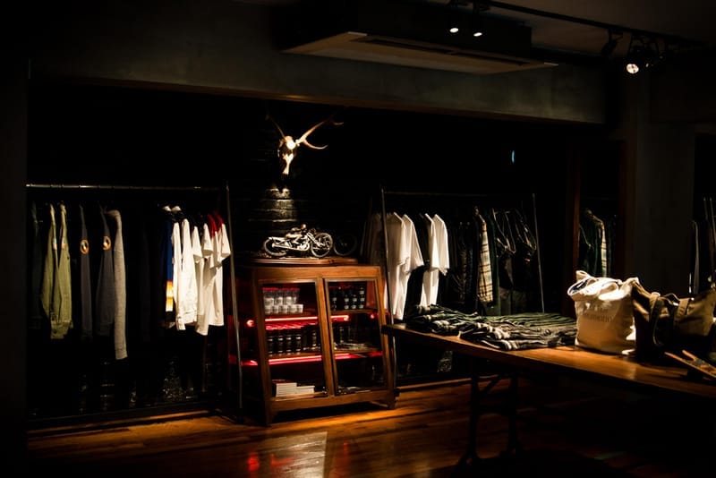 Clothing racks, a deer skull, miniature motorcycles and a NEIGHBORHOOD tote inside the Shibuya store.