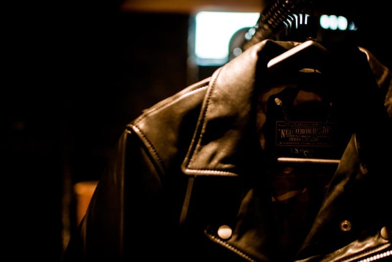 Black leather motorcycle jacket with a NEIGHBORHOOD Urban Garment label.