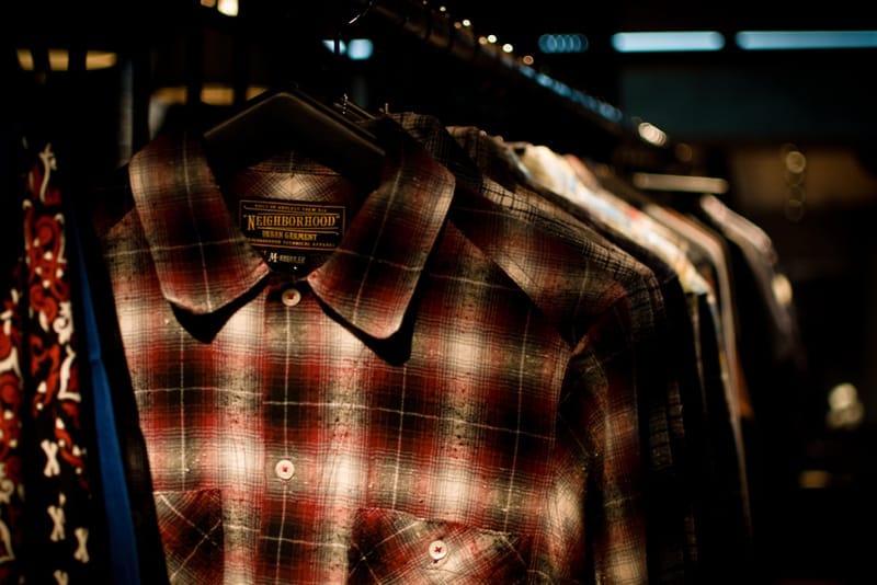 Red, black and white plaid shirt with a NEIGHBORHOOD Urban Garment neck label.