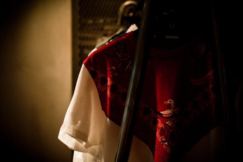 Red and white graphic short-sleeve shirt on a NEIGHBORHOOD hanger.