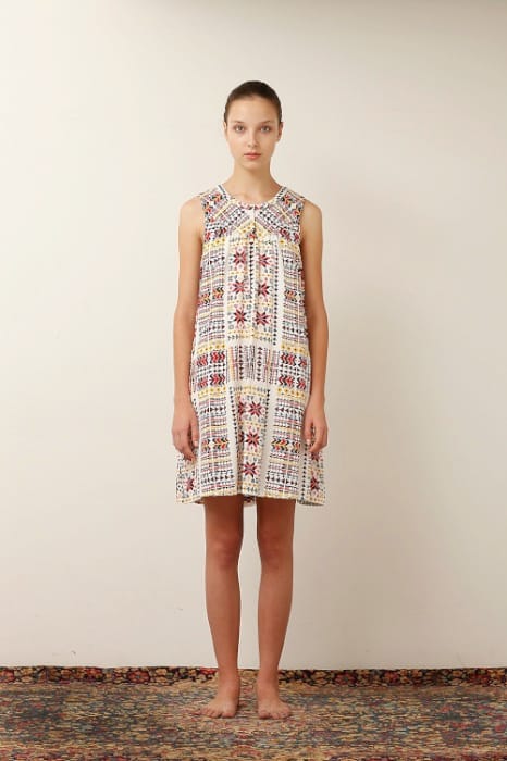 White Mountaineering womenswear model in a sleeveless multicolour geometric-patterned dress.