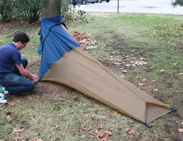 Justin Gargasz's blue-and-tan Vessel cocoon tent anchored around a tree.