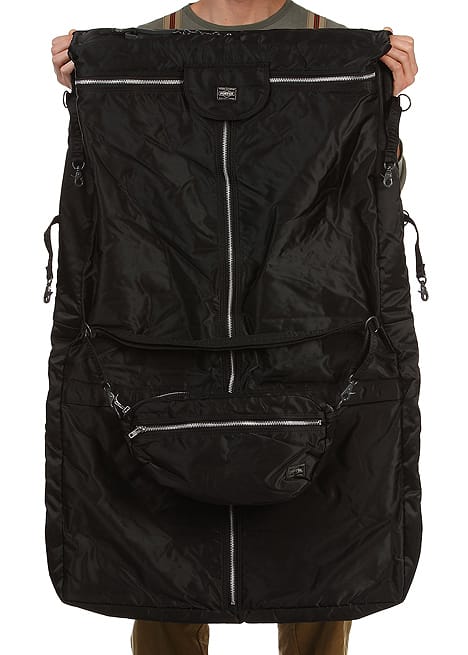 Porter Tanker garment bag unfolded to show its black exterior pockets and detachable Tanker sling bag.