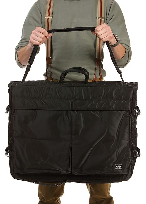 Porter Tanker garment bag folded for hand carry, showing the front storage panels and padded handles.