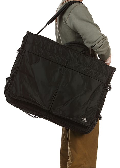 Porter Tanker garment bag carried over the shoulder in its folded travel configuration.