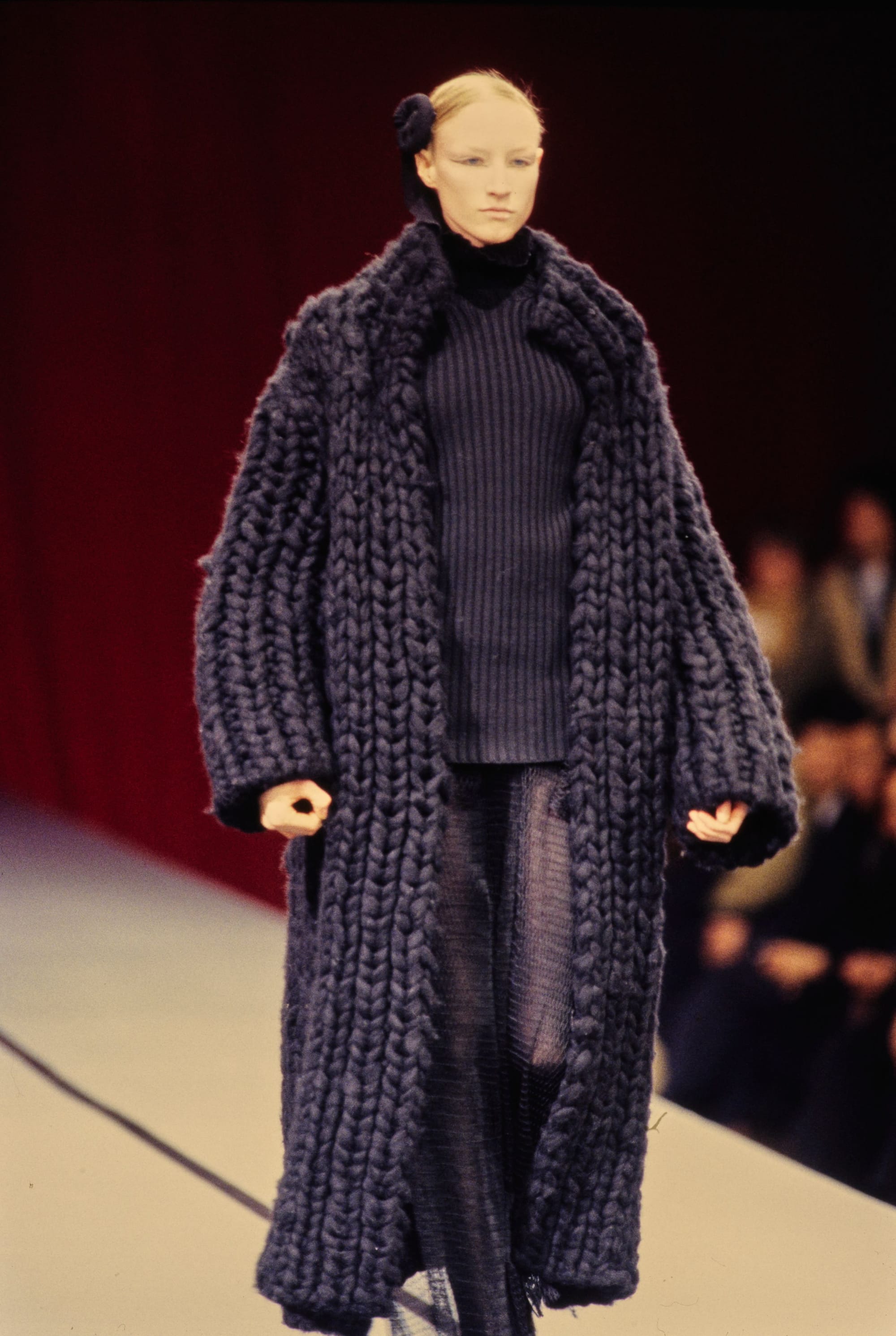 Yohji Yamamoto Fall 1995 detail 32: Chunky charcoal knitted long coat over a ribbed dark top and knit skirt.