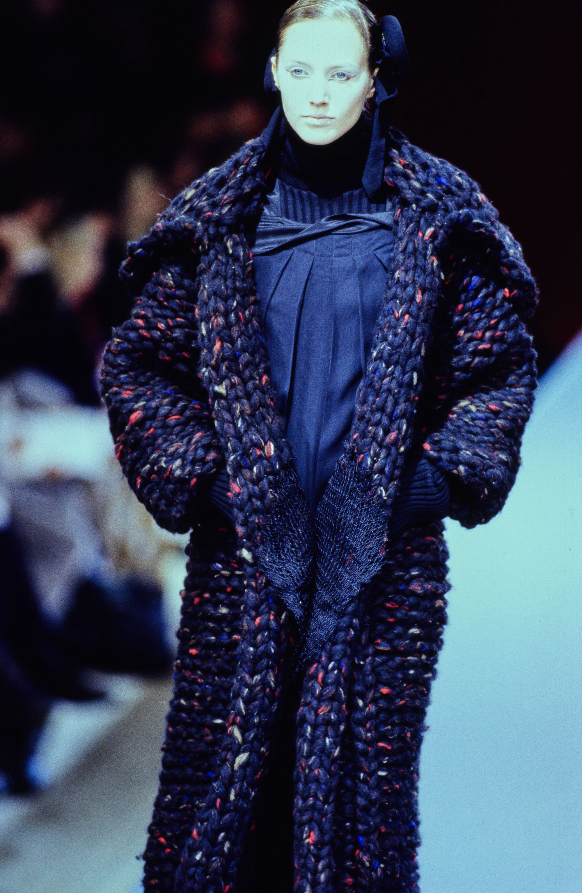 Yohji Yamamoto Fall 1995 detail 35: Dark blue flecked chunky knit coat over a high-neck navy dress.