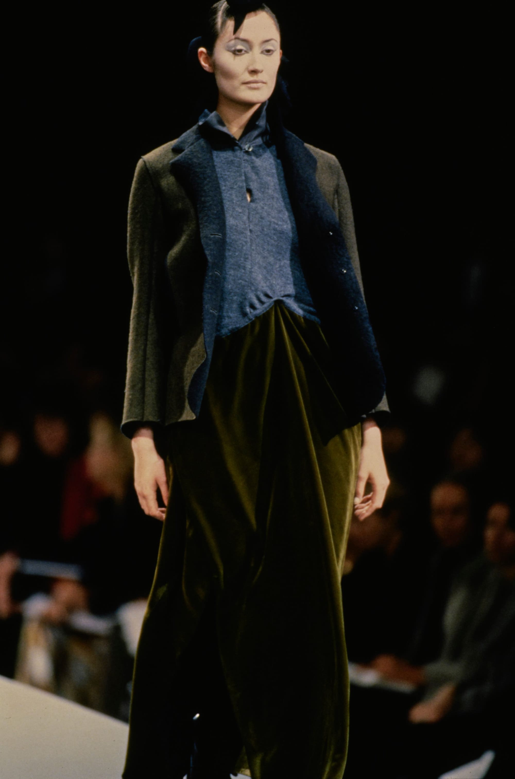Yohji Yamamoto Fall 1995 detail 48: Olive jacket over a grey shirt and flowing olive lower garment.