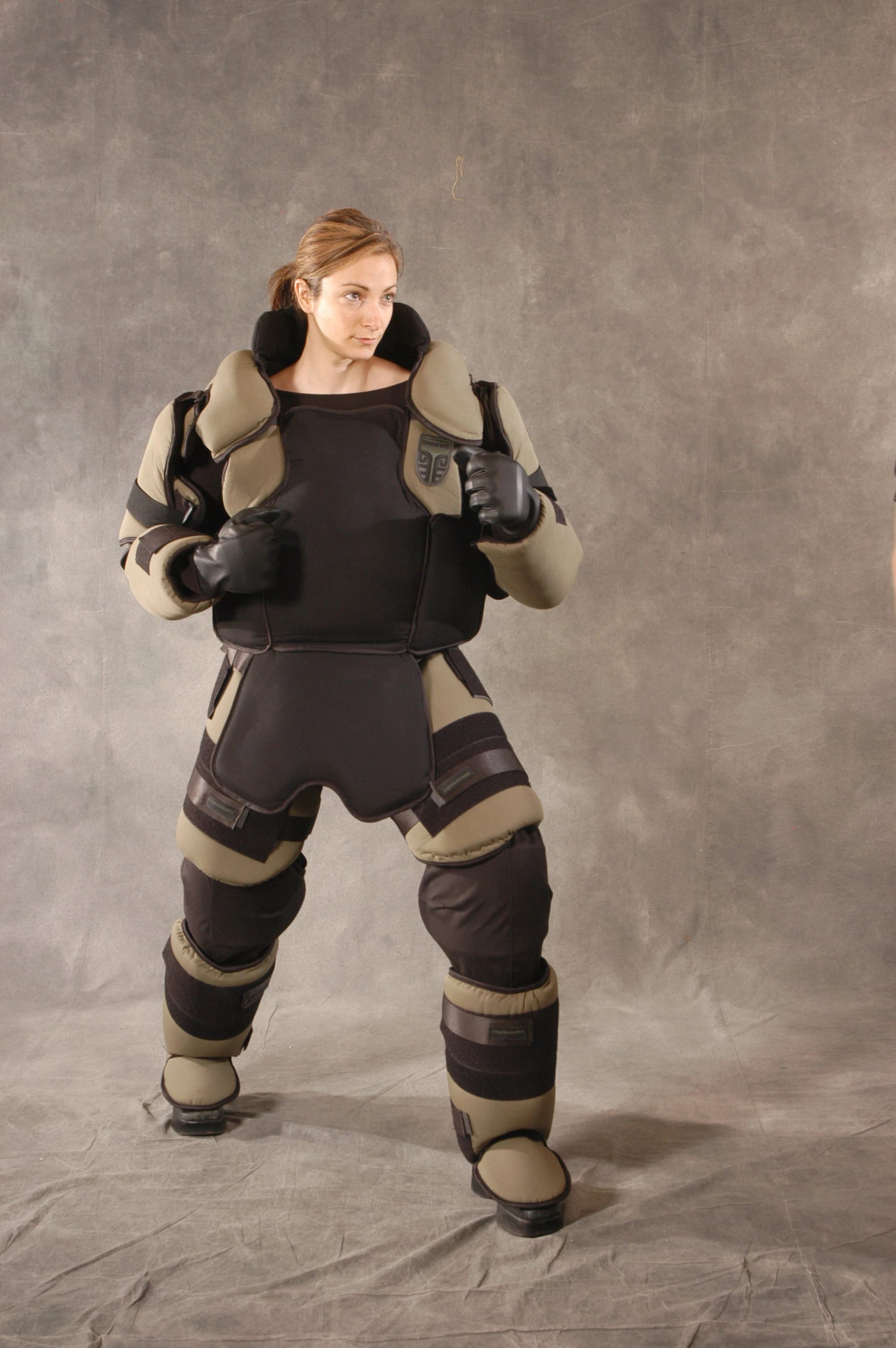 Mawashi T-RED use-of-force training suit in khaki and black, front view without helmet.