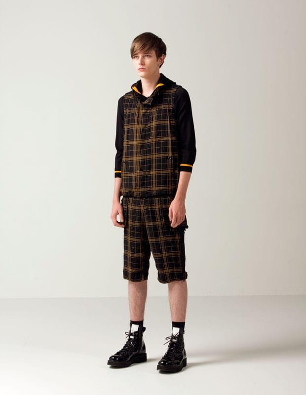 Man of Moods black-and-yellow plaid sleeveless hooded top with matching knee-length shorts.