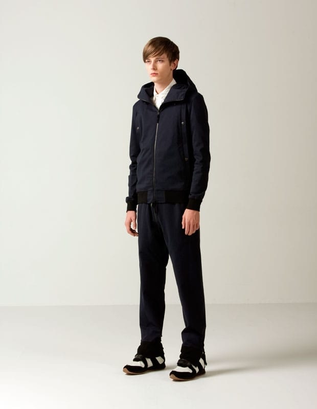 Male model in a navy Man of Moods hooded zip jacket with matching drawstring trousers.