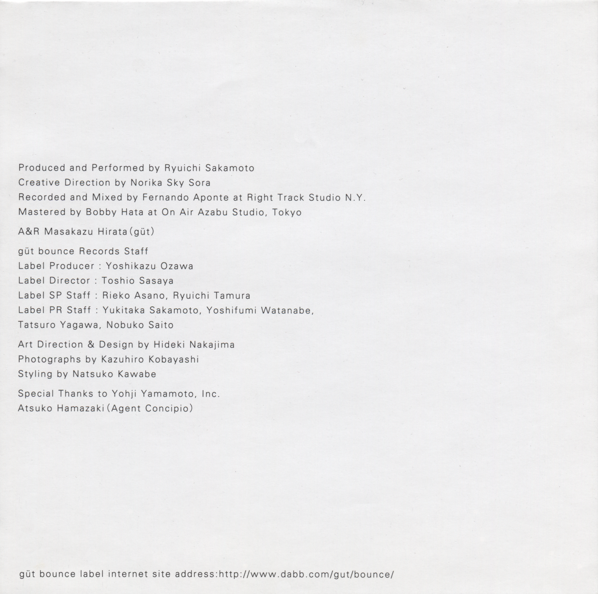 White insert printed with production, design, photography and styling credits for Ryuichi Sakamoto’s CD.