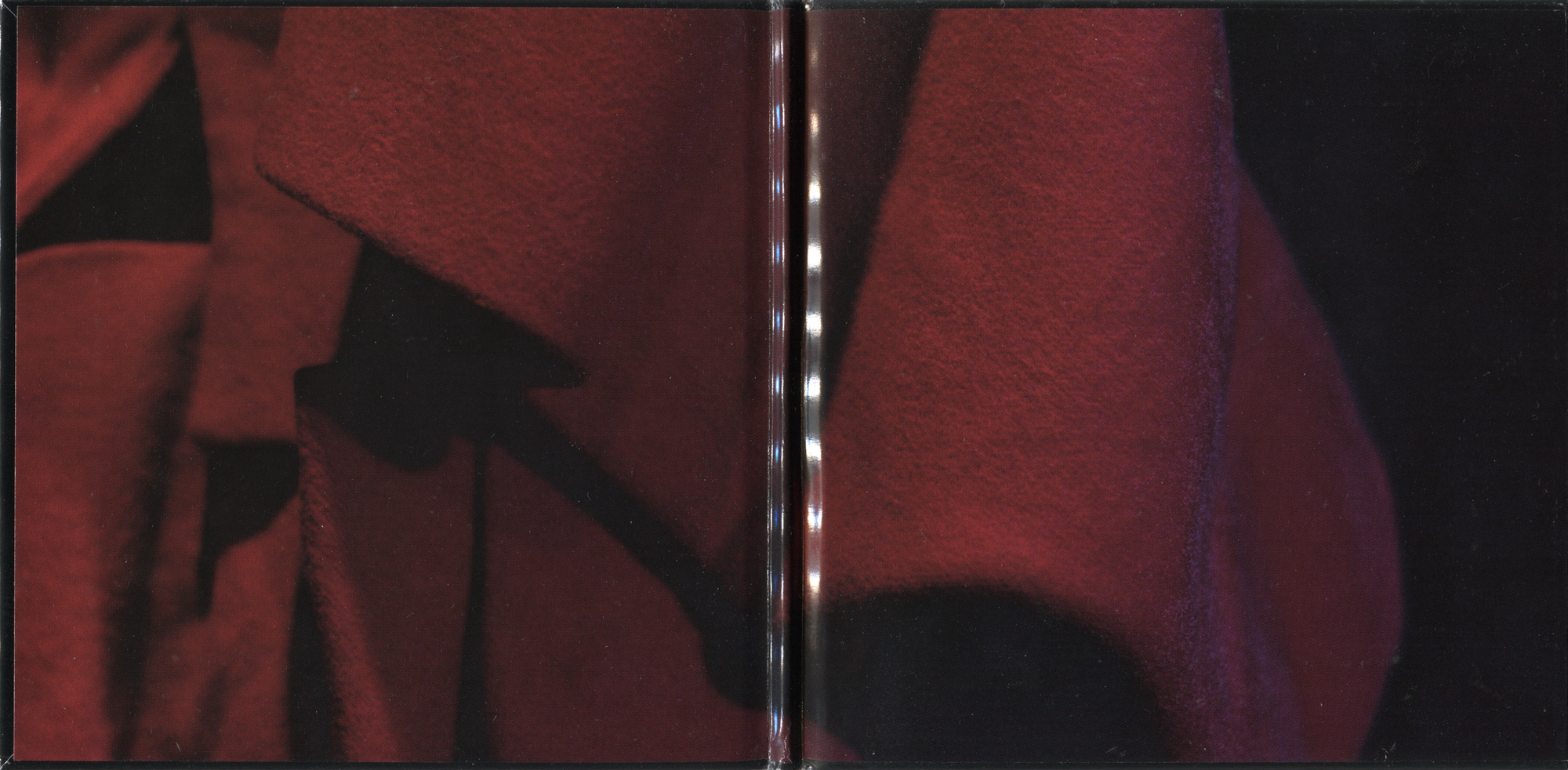 Inside CD case spread with abstract dark red, burgundy and black textile artwork.