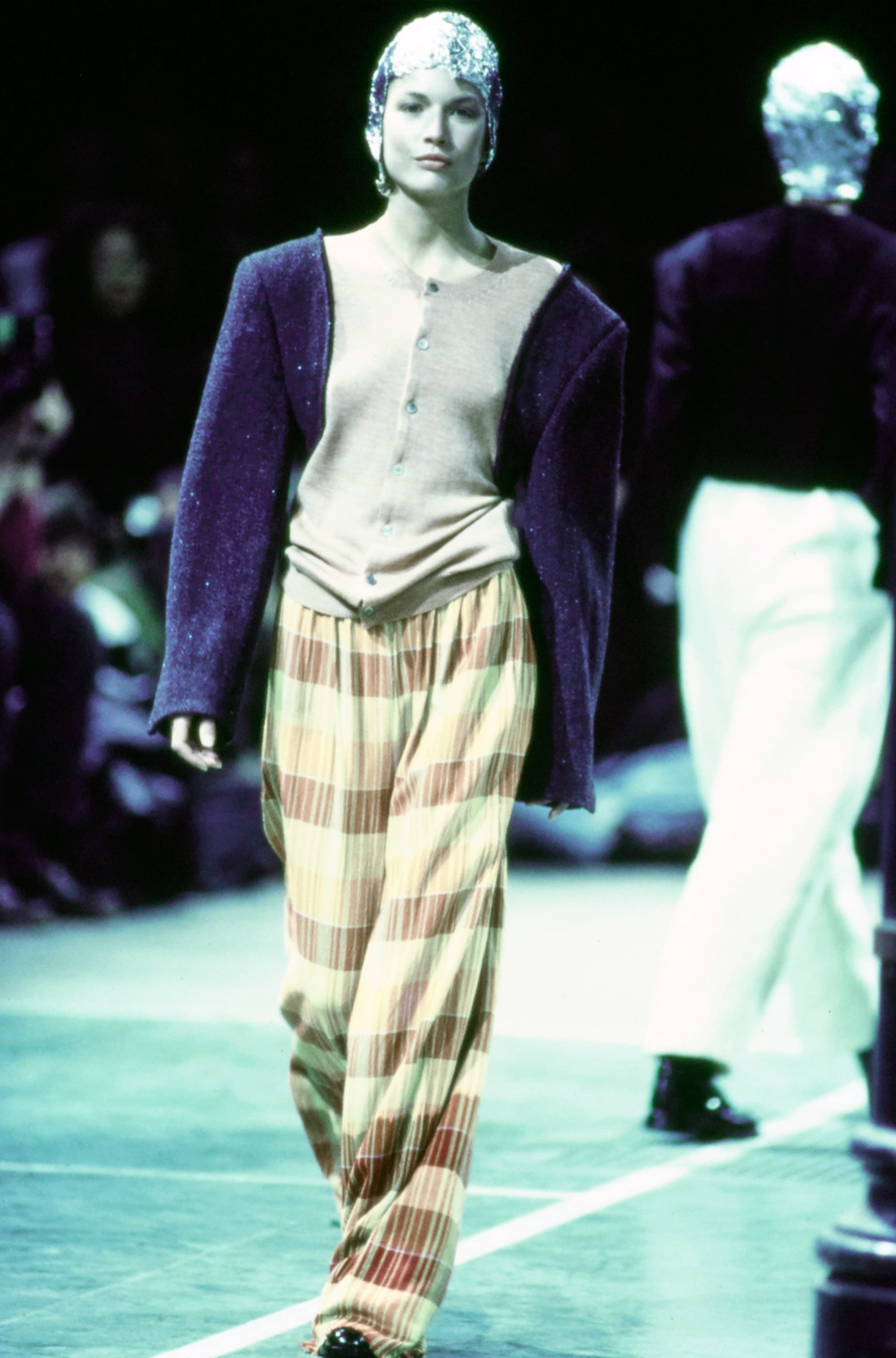 Comme des Garçons Fall 1993 Ready-to-Wear runway look 16: pale sleeveless top with striped loose trousers.