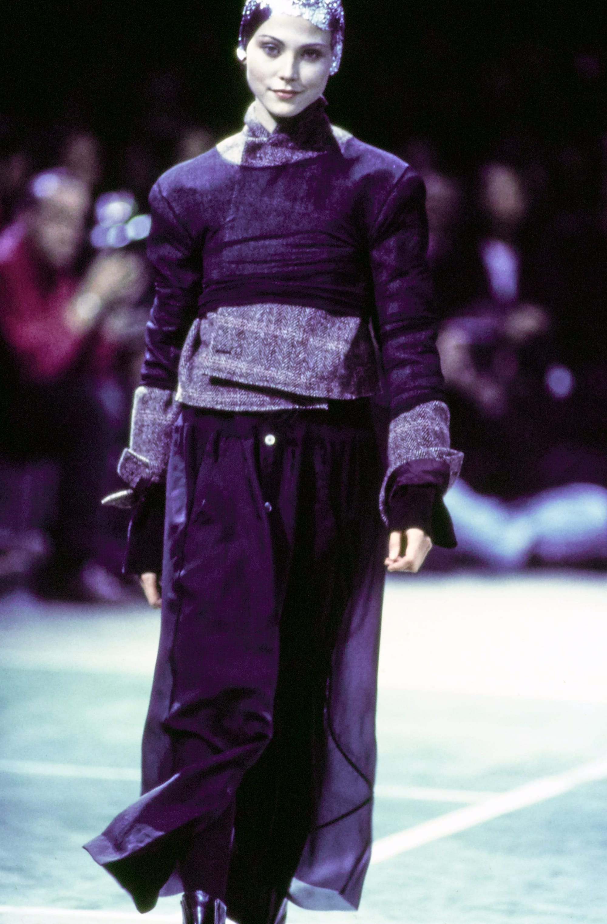 Comme des Garçons Fall 1993 Ready-to-Wear runway look 18: purple textured cropped jacket with dark trousers.