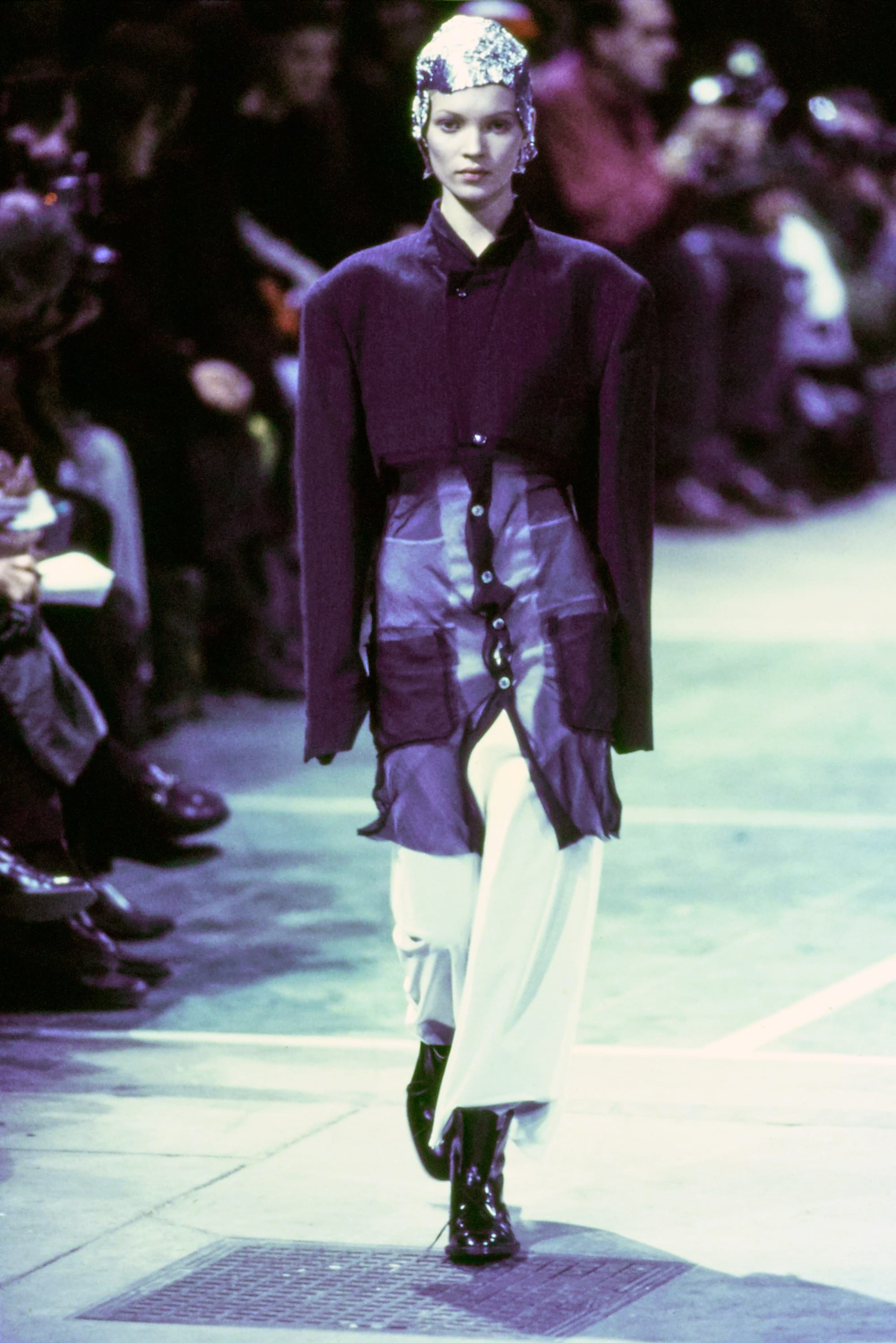 Comme des Garçons Fall 1993 Ready-to-Wear runway look 21: purple tailored jacket and short skirt over white leggings.