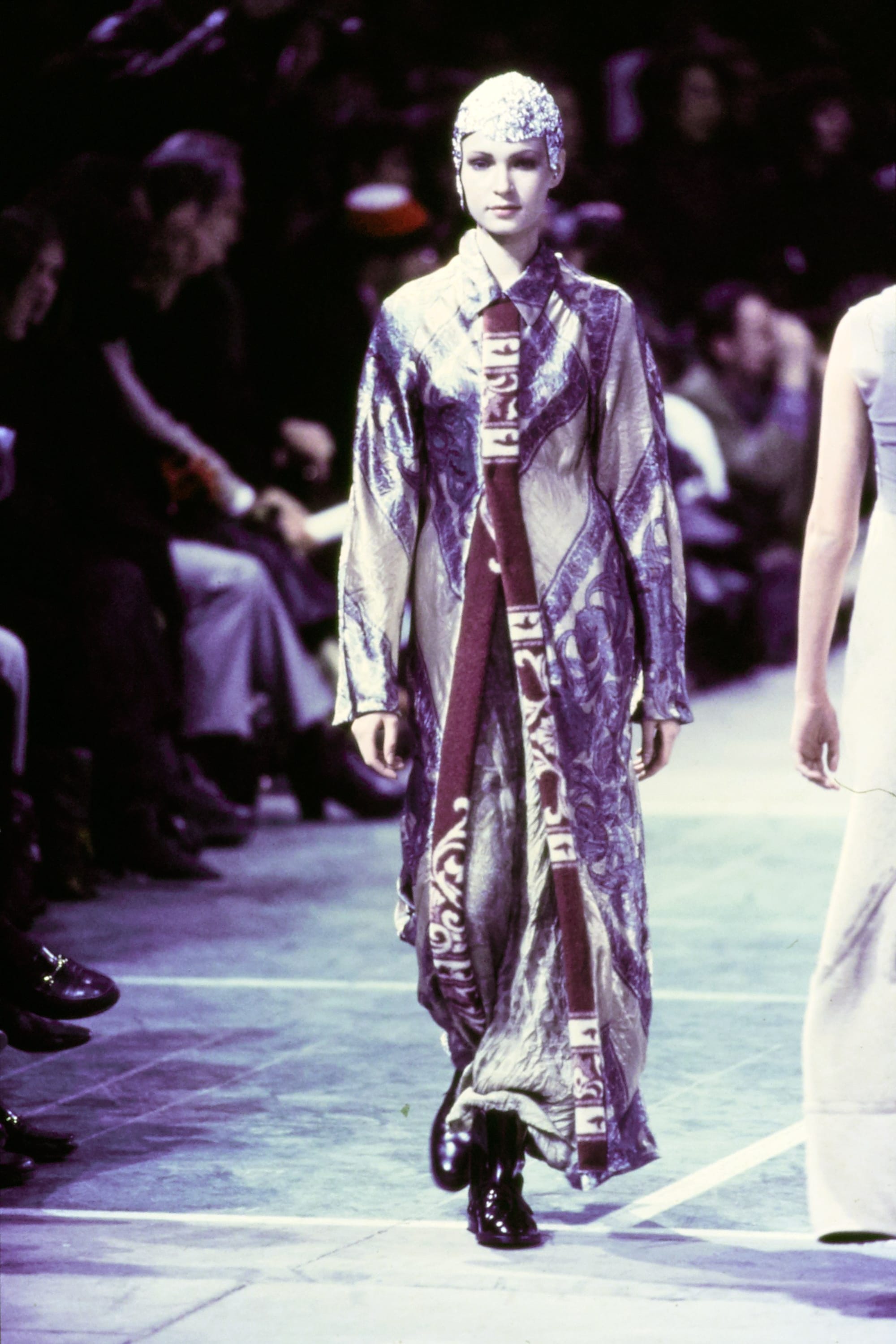 Comme des Garçons Fall 1993 Ready-to-Wear runway look 29: reflective silver long coat over a pale outfit.