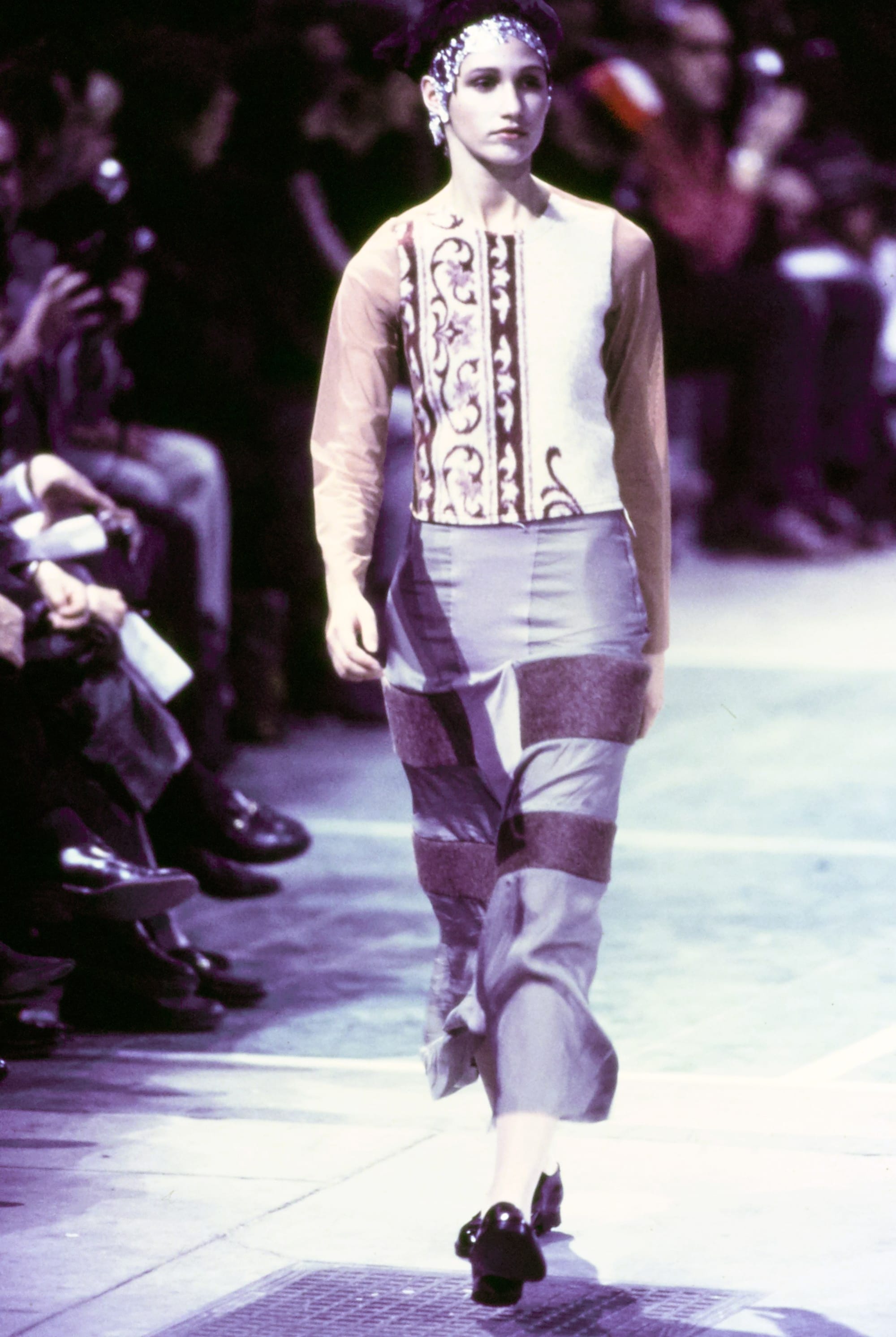 Comme des Garçons Fall 1993 Ready-to-Wear runway look 32: cream tank with geometric panel and striped leggings.