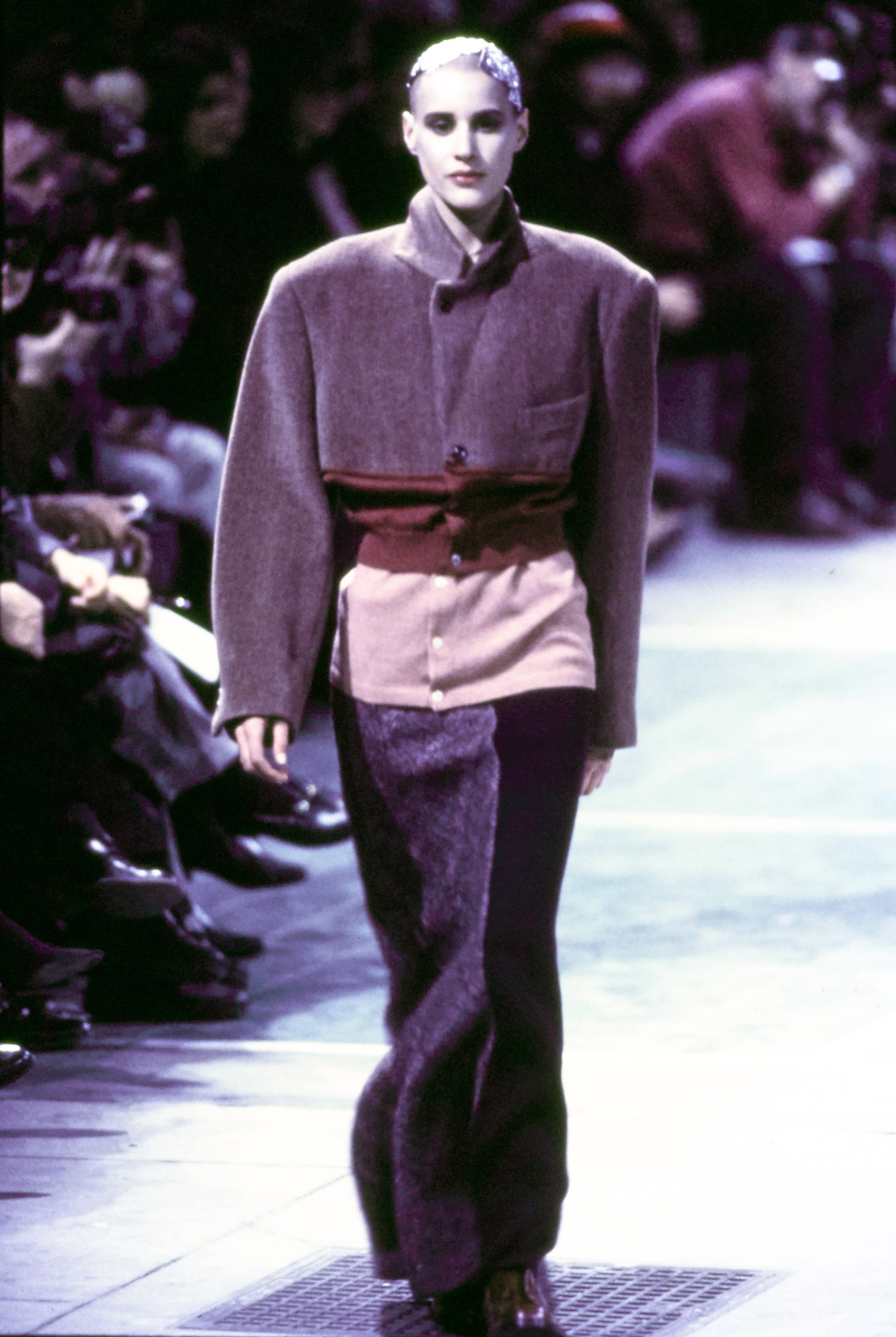 Comme des Garçons Fall 1993 Ready-to-Wear runway look 35: purple fitted top with a wide black waistband and dark trousers.