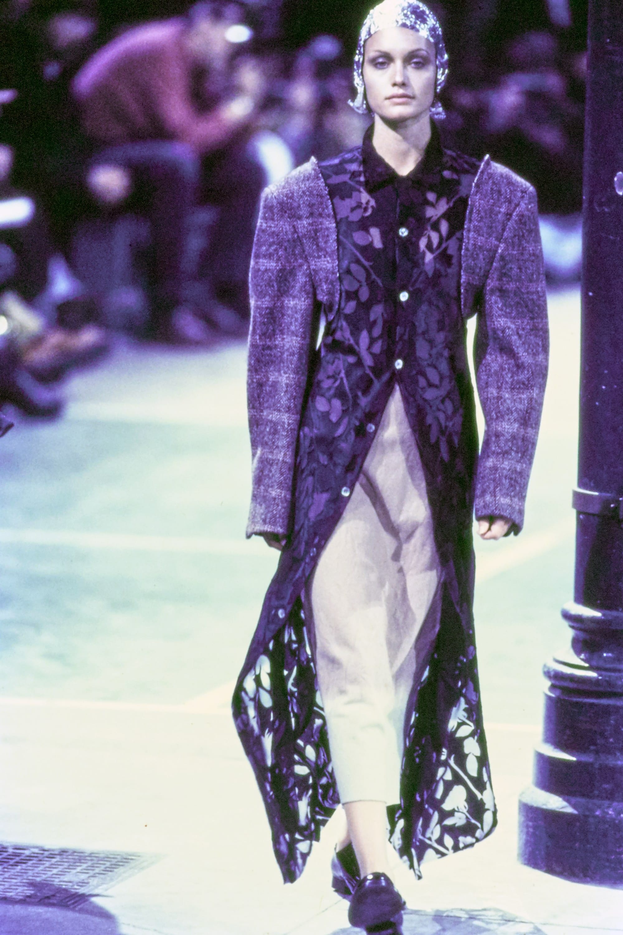 Comme des Garçons Fall 1993 Ready-to-Wear runway look 45: purple patterned jacket with reflective pale trousers.