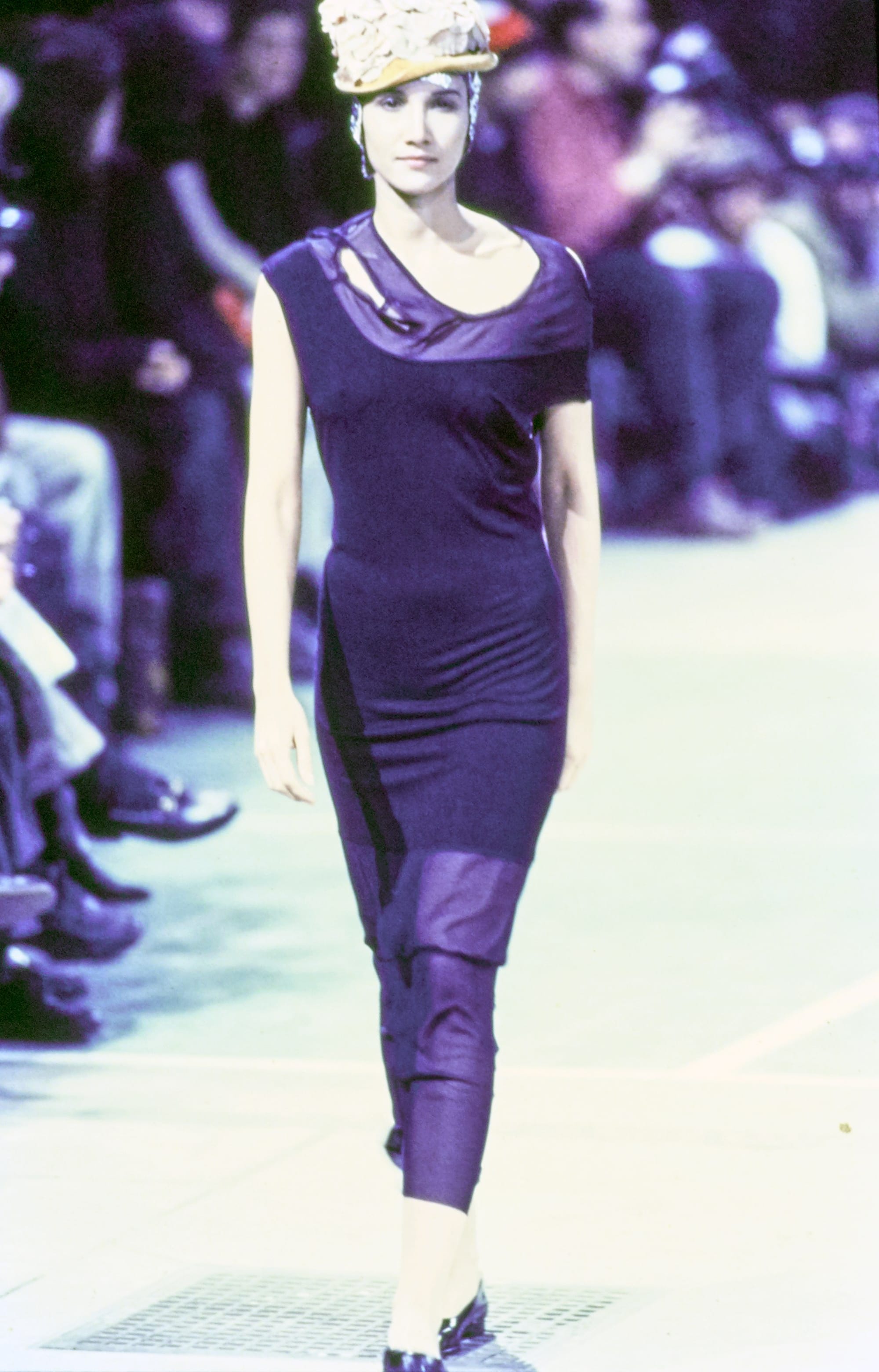 Comme des Garçons Fall 1993 Ready-to-Wear runway look 61: purple sleeveless asymmetrical dress over trousers.