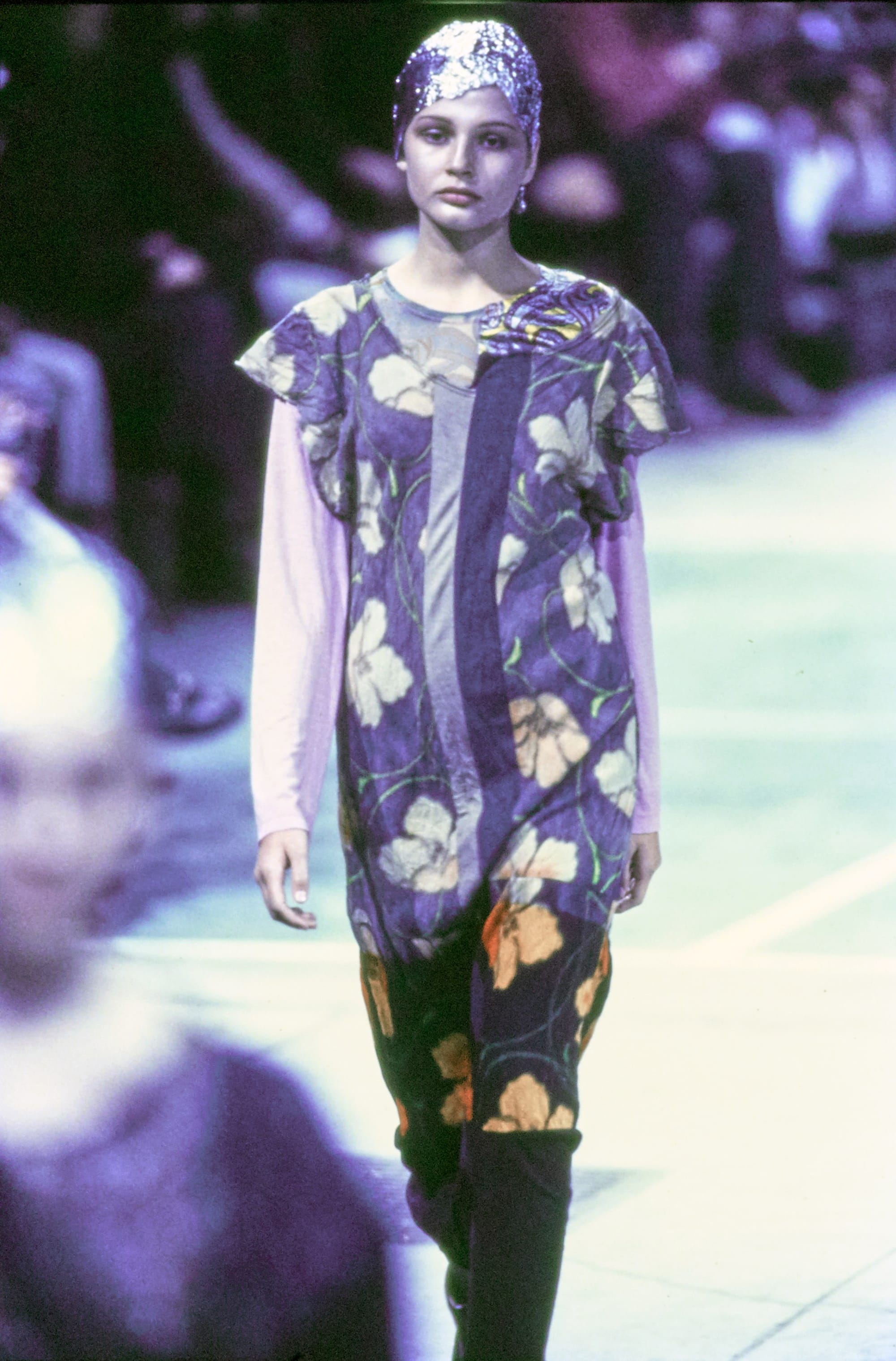 Comme des Garçons Fall 1993 Ready-to-Wear runway look 66: purple floral dress with a dark hem.